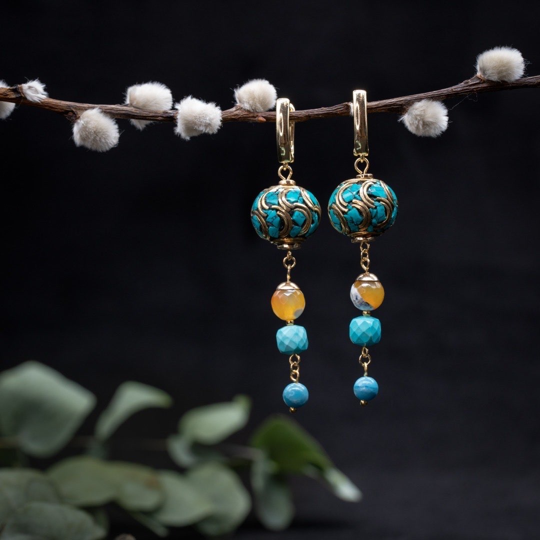 Tidal Mosaic earrings hanging from a natural branch