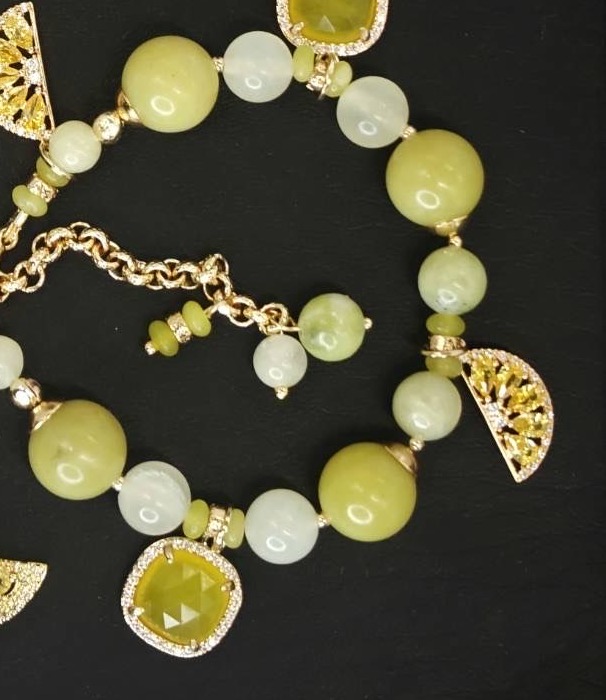 Verdant Light bracelet with green beads and gold-toned charms